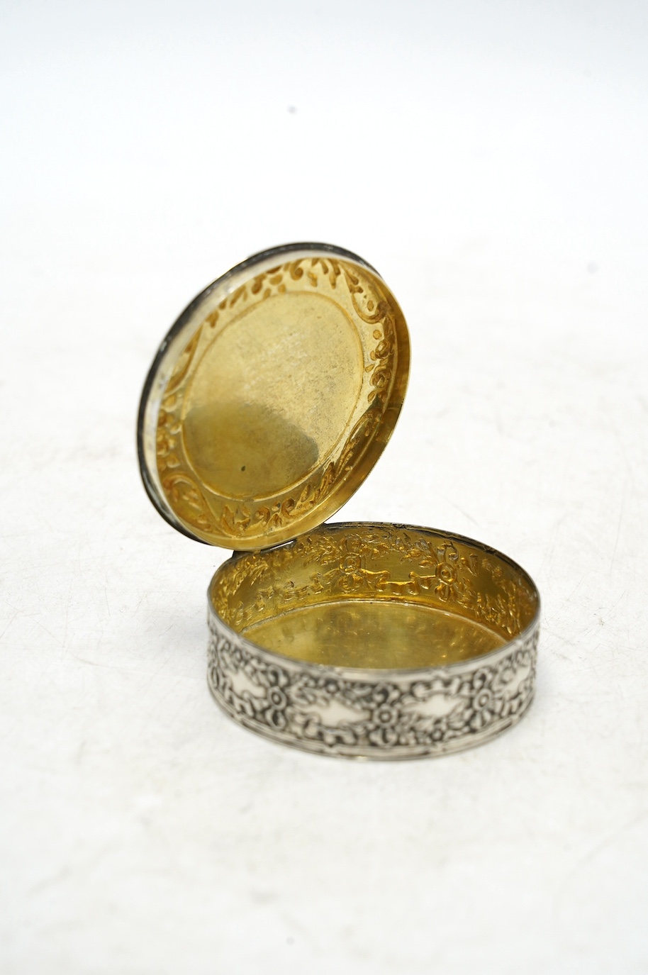 An early 20th century continental white metal circular snuff box, the cover with inset miniature watercolour of a lady signed Drepize?, 58mm. Condition - fair to good